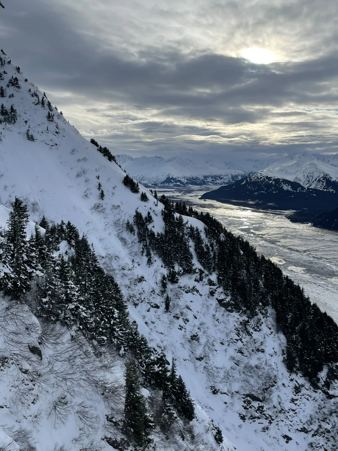 Snow-covered ridge above a cloud-filled valley